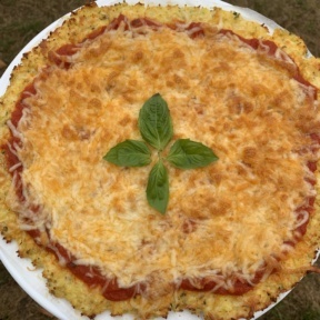 Gluten-free Cauliflower Pizza Crust with cheese and basil