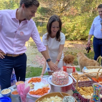Jackie and Brendan cutting the cake at Gluten-Free Gender Reveal Party