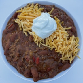 Gluten-free chili with cheddar cheese and sour cream