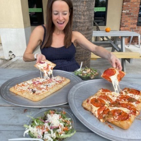Jackie eating gluten-free pizza from Slice Co. in Charleston