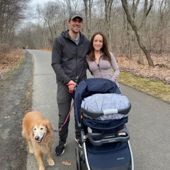 Jackie, Brendan, Chloe, and Odie on a walk with her stroller