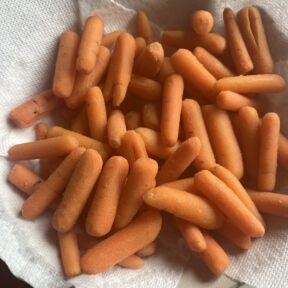 Steaming carrots to make Cheesy Smashed Carrots